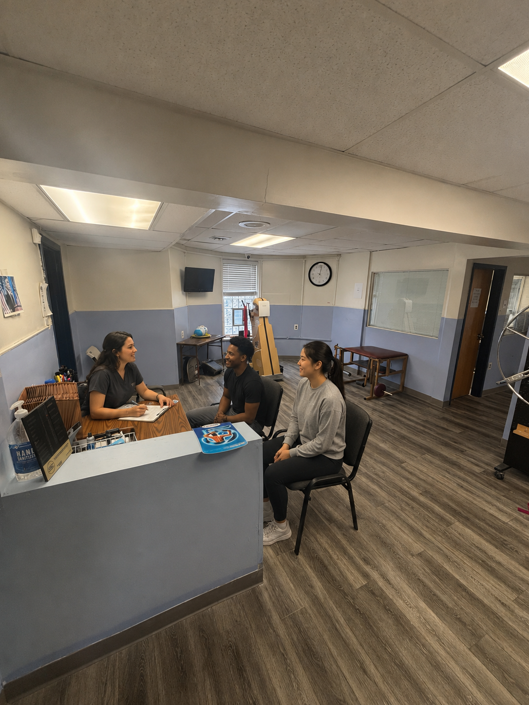 Nurse practitioner greeting patients at the reception desk of the Chew Avenue medical office